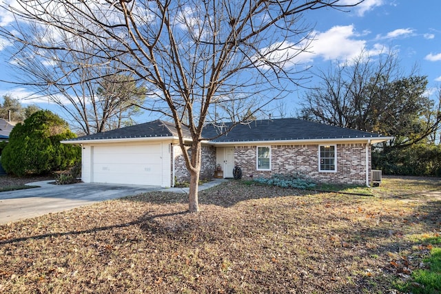 ranch-style home featuring a garage and central AC unit