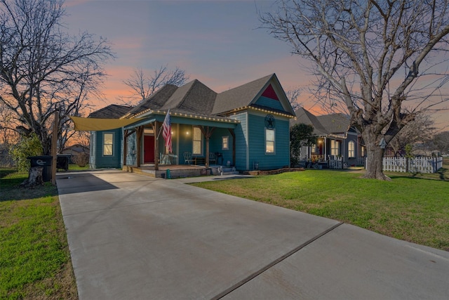 view of front of property with a yard and covered porch