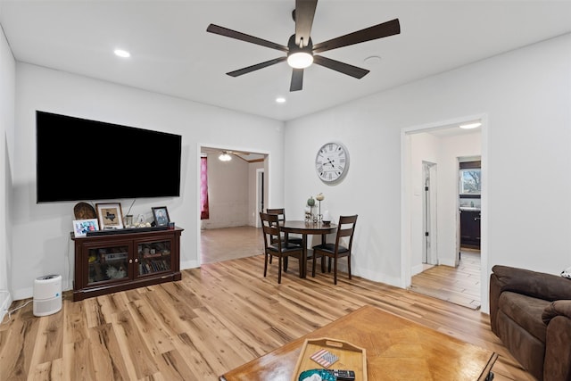 living room featuring wood-type flooring and ceiling fan