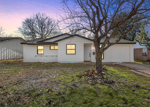 exterior space with a garage and a lawn