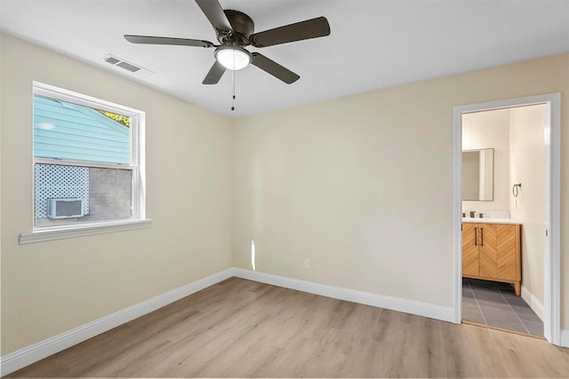 spare room with ceiling fan and light hardwood / wood-style floors