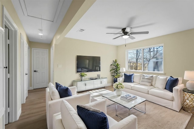 living room with hardwood / wood-style flooring and ceiling fan