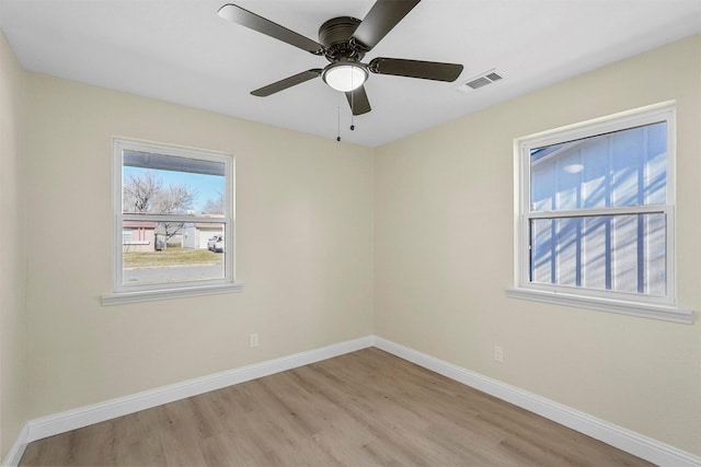 spare room with ceiling fan and light wood-type flooring