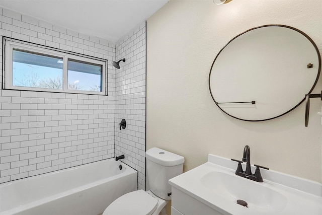 full bathroom with tiled shower / bath, vanity, and toilet