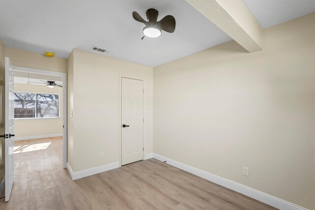 unfurnished bedroom with ceiling fan and light hardwood / wood-style flooring