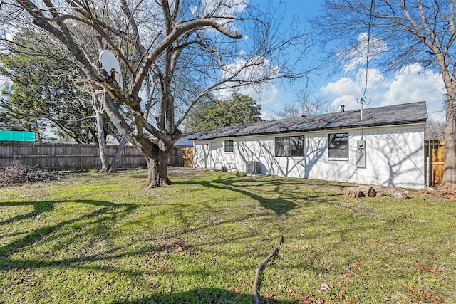 back of property featuring cooling unit and a lawn