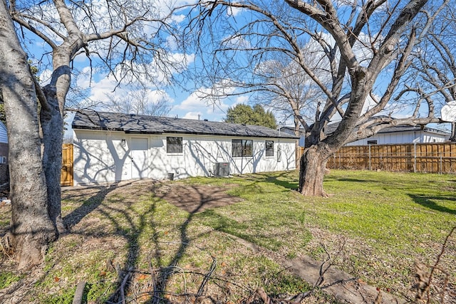 back of house with a yard and central air condition unit