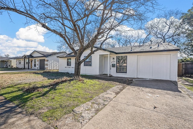 single story home with a garage and a front lawn