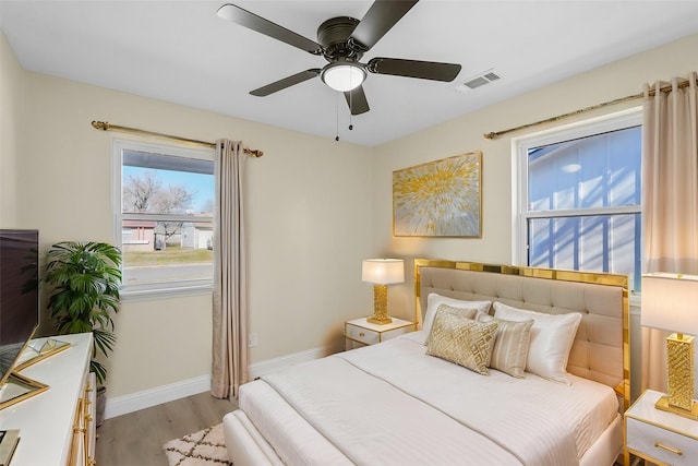 bedroom with ceiling fan and light hardwood / wood-style flooring