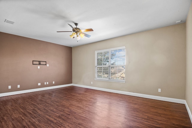 unfurnished room with ceiling fan and dark hardwood / wood-style floors