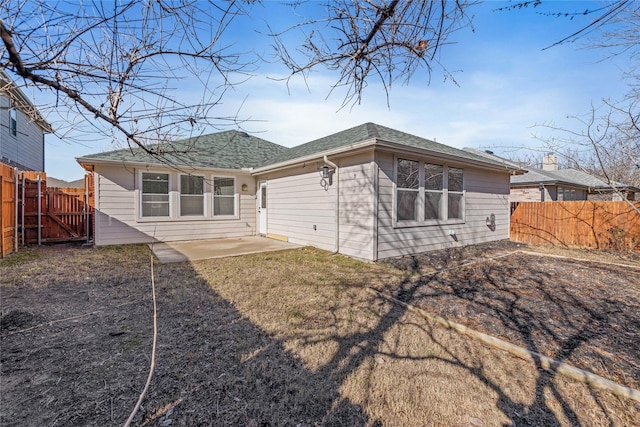 back of property with a patio