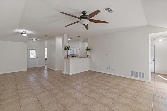 unfurnished living room with lofted ceiling, ceiling fan, and light tile patterned floors