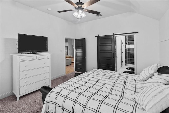 bedroom featuring baseboards, visible vents, carpet floors, lofted ceiling, and a barn door