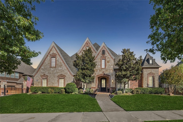 english style home with a yard