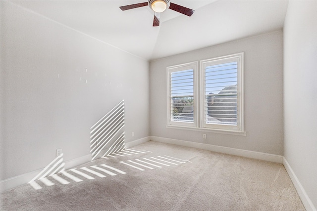 empty room with light carpet, ceiling fan, and vaulted ceiling