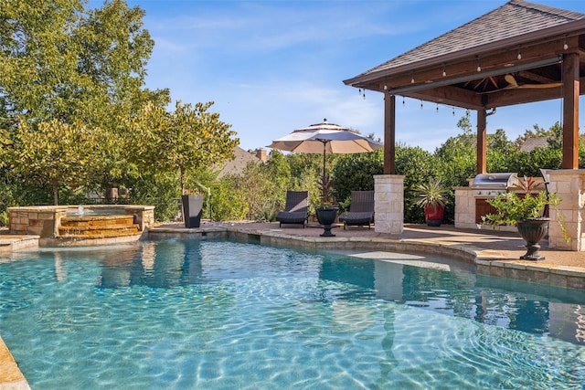 view of swimming pool with exterior kitchen, a gazebo, area for grilling, an in ground hot tub, and a patio