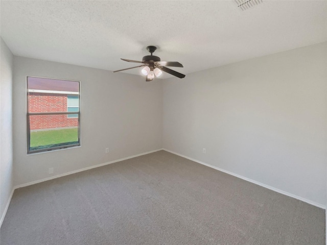 spare room featuring carpet flooring, ceiling fan, and a textured ceiling