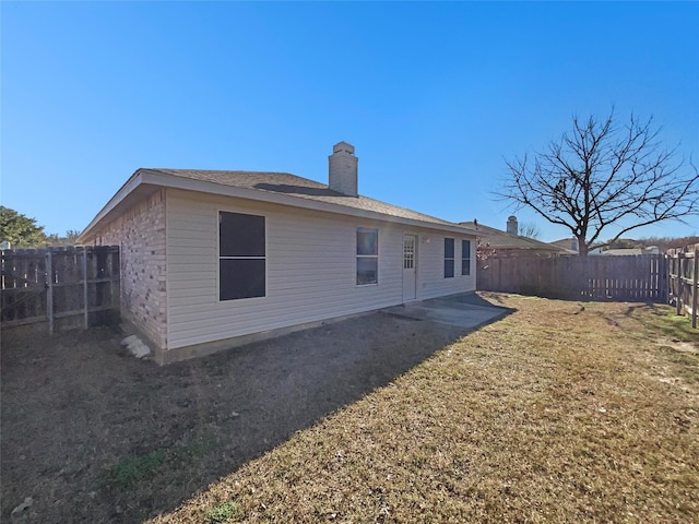 back of house with a yard