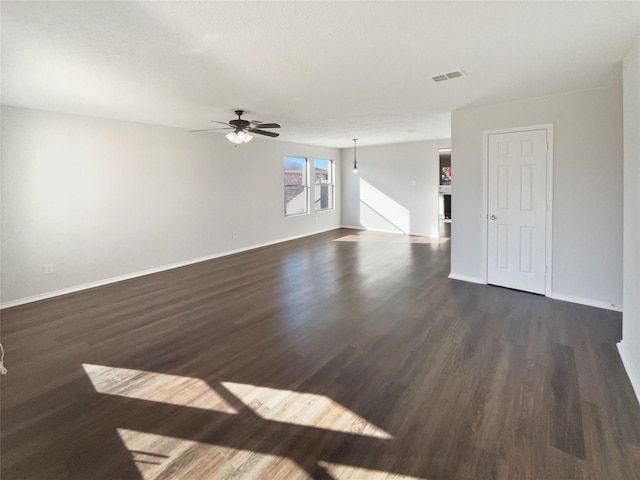 unfurnished living room featuring dark hardwood / wood-style flooring and ceiling fan