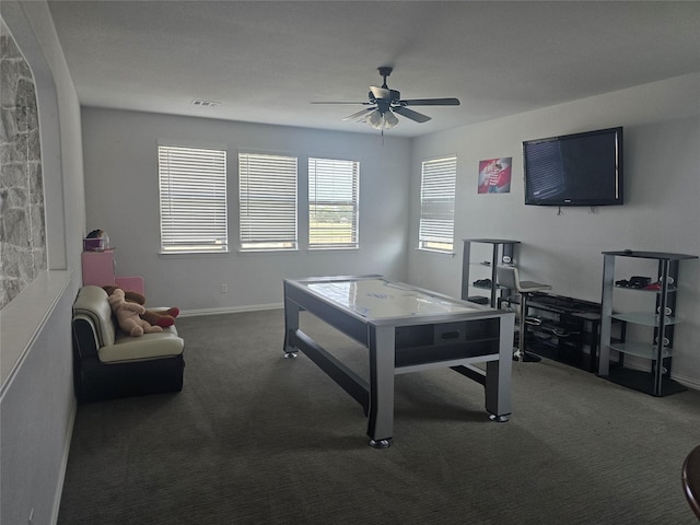 recreation room featuring dark carpet and ceiling fan