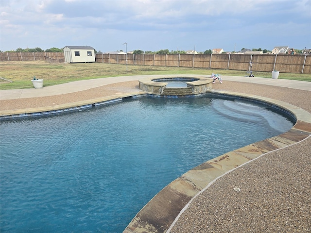 view of pool featuring an in ground hot tub and a storage shed