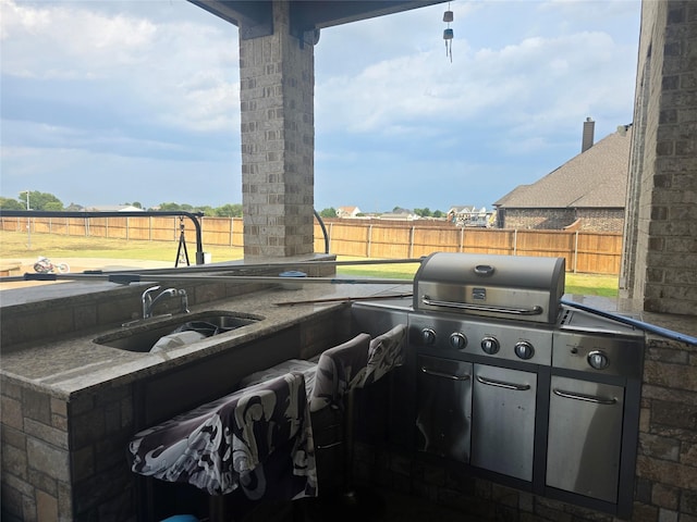 view of patio / terrace featuring area for grilling and sink