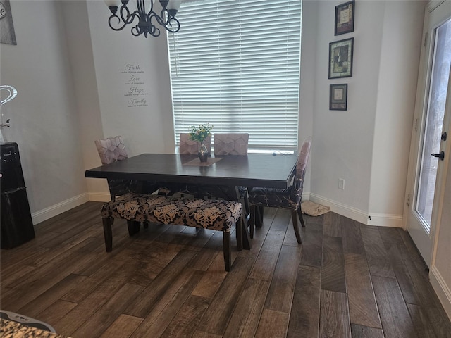 dining area with a chandelier, plenty of natural light, and dark wood-type flooring