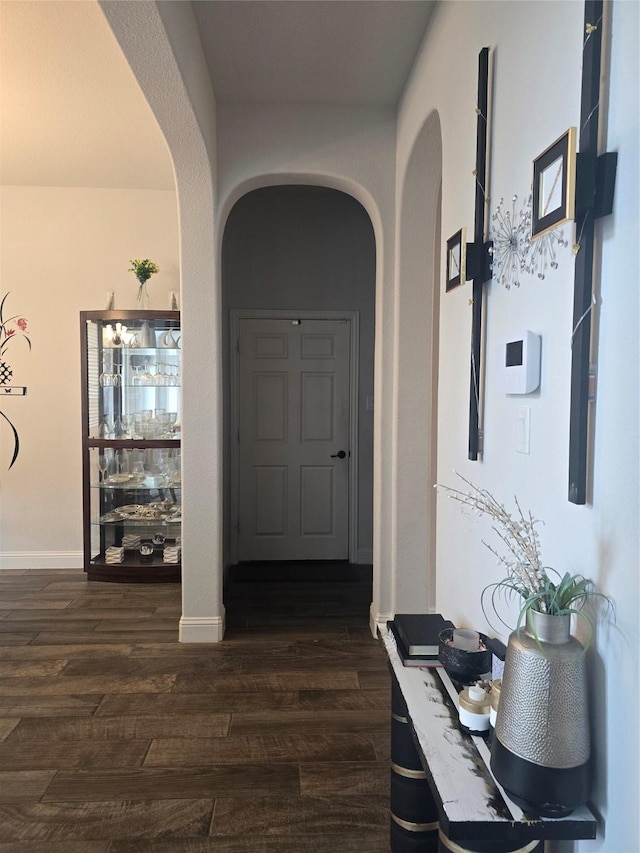 hallway with dark hardwood / wood-style flooring