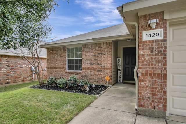 doorway to property with a yard