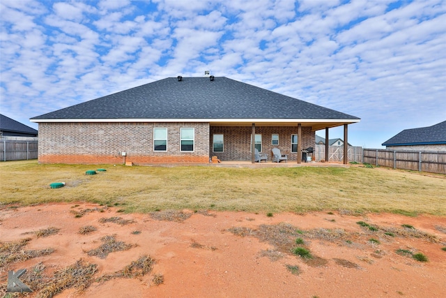 back of house featuring a yard and a patio