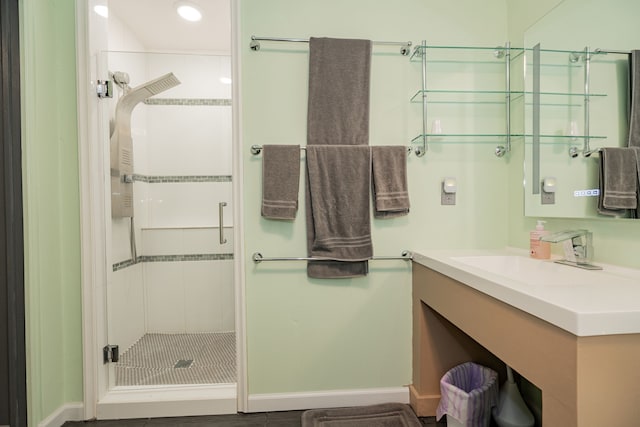 bathroom with a shower with door and vanity