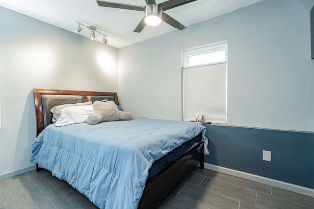 bedroom featuring ceiling fan and rail lighting