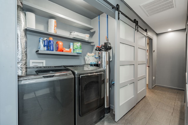 washroom featuring a barn door and independent washer and dryer