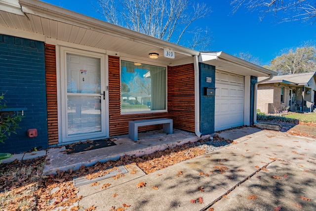 view of exterior entry featuring a garage