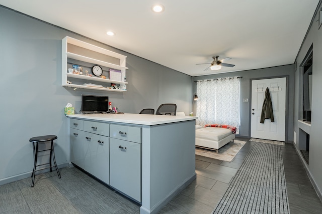 kitchen featuring ceiling fan and kitchen peninsula