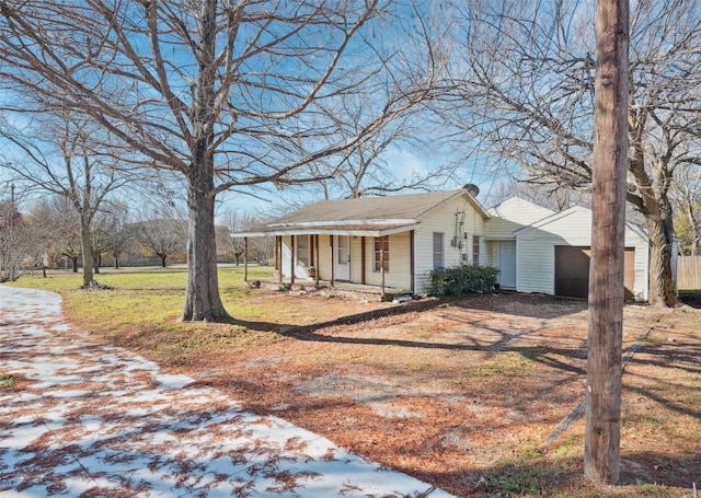 exterior space featuring a garage, a lawn, and a porch