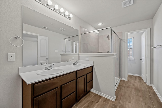 bathroom with vanity and a shower with shower door