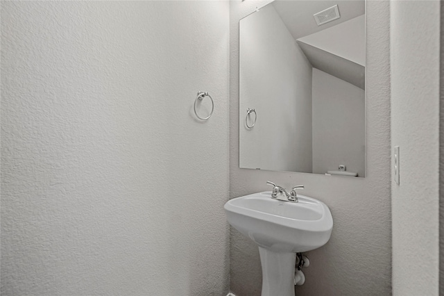 bathroom with lofted ceiling