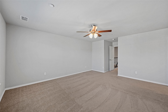 unfurnished room featuring light colored carpet and ceiling fan