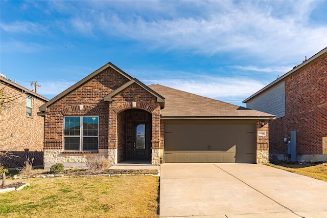 view of front of home with a front yard and a garage