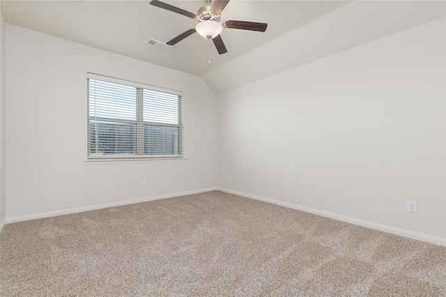 carpeted empty room with ceiling fan and lofted ceiling