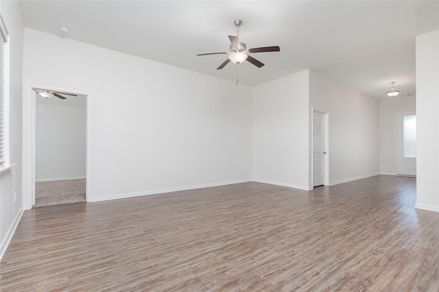 empty room with ceiling fan and hardwood / wood-style floors