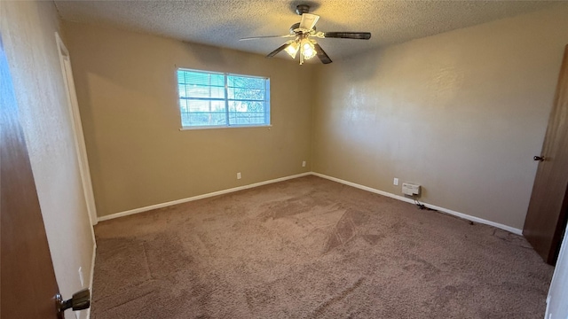 carpeted spare room featuring ceiling fan and a textured ceiling