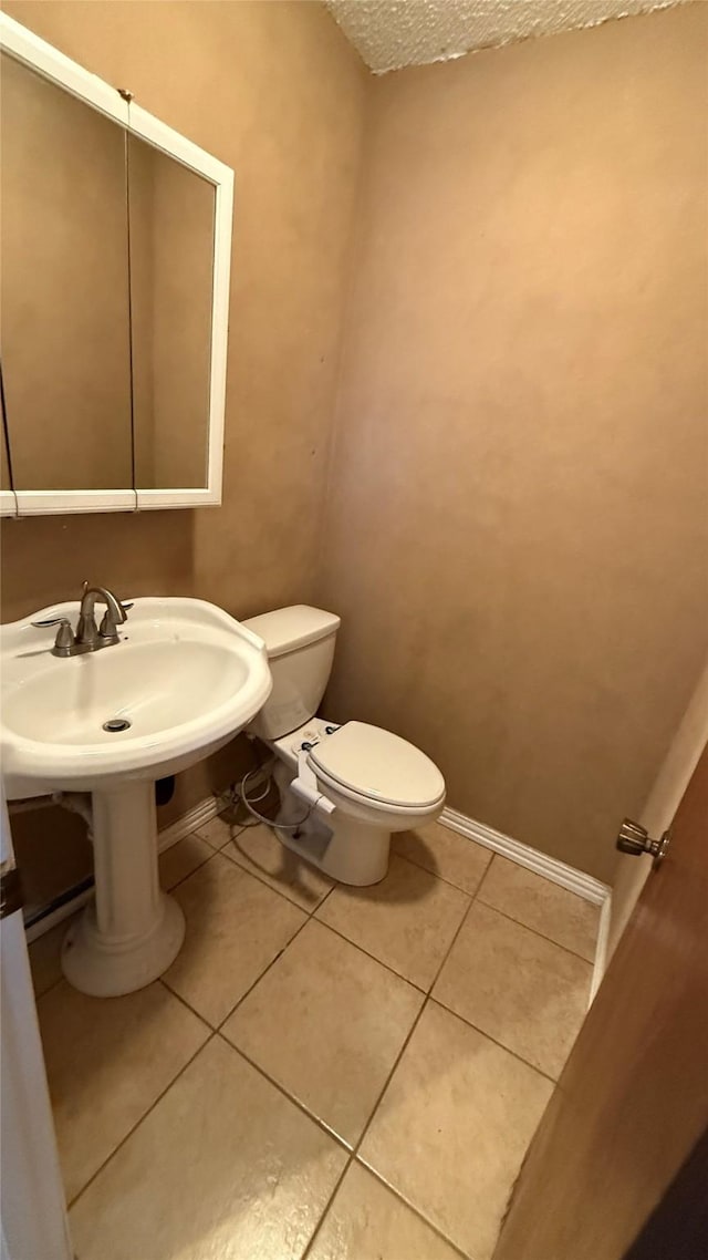 bathroom featuring tile patterned floors and toilet