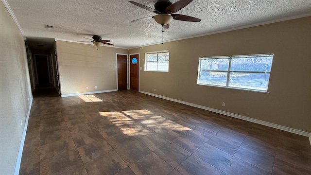 spare room featuring ornamental molding, ceiling fan, and a textured ceiling