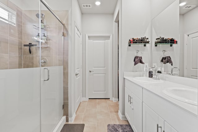 bathroom featuring tile patterned floors, vanity, and an enclosed shower