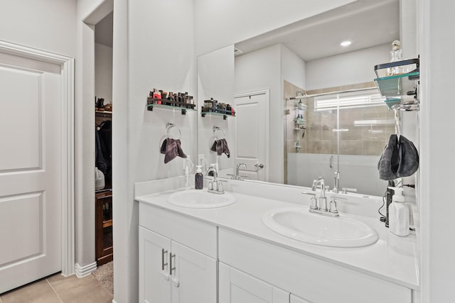 bathroom featuring tile patterned flooring, vanity, and a shower with shower door