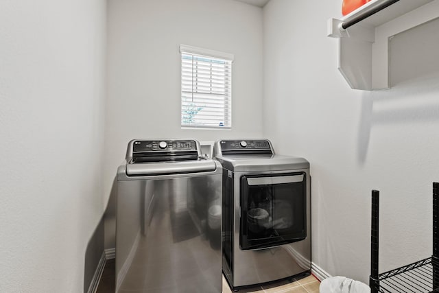 laundry room featuring independent washer and dryer and light tile patterned floors