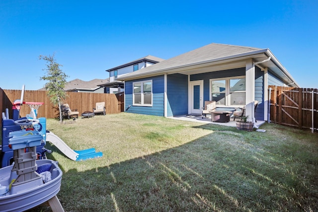 back of property with a yard and a patio area