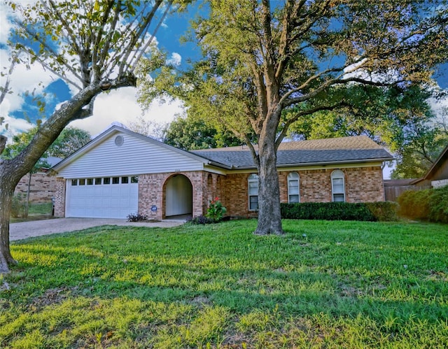 ranch-style home with a garage and a front yard